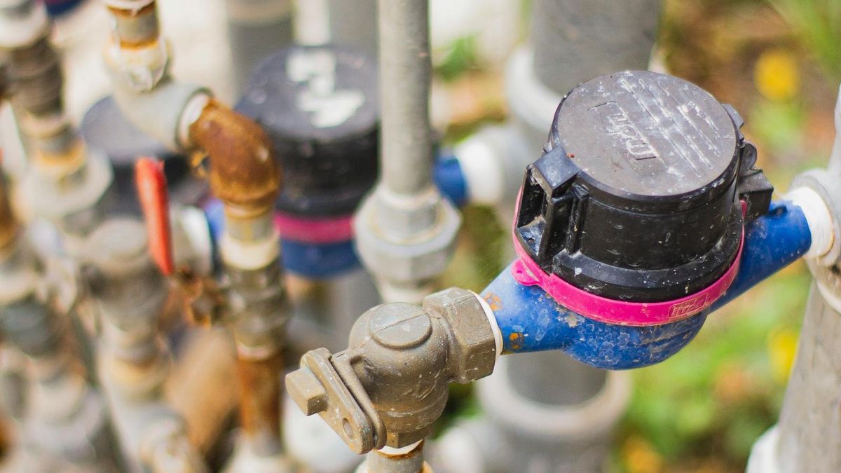 Outdoor water meter and brass plumbing valves used in residential backflow prevention assemblies