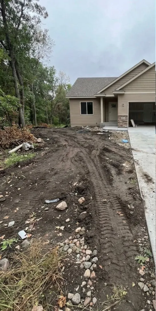 New construction yard before: rough-graded dirt with rocks and equipment tracks