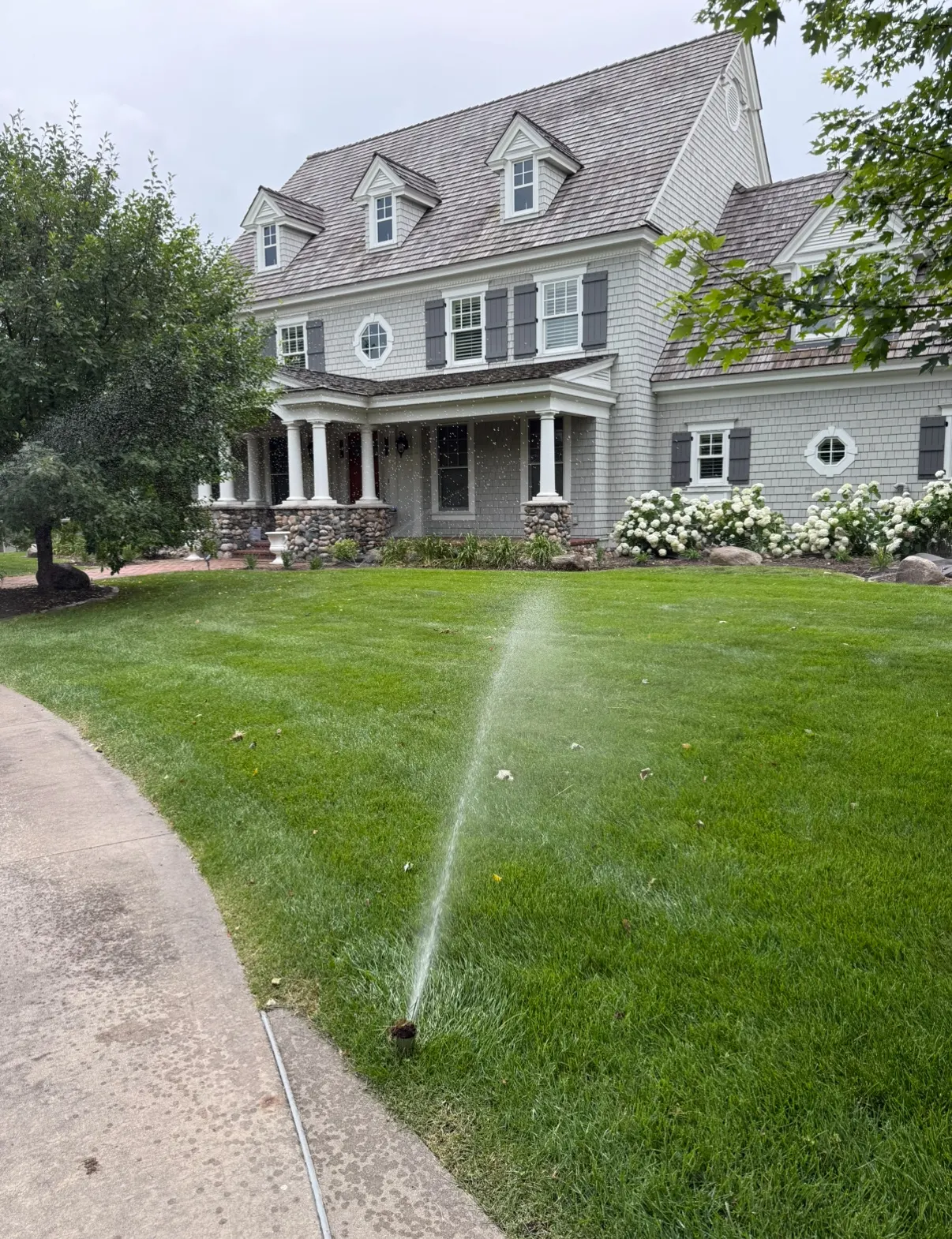 Luxury home sprinkler running
